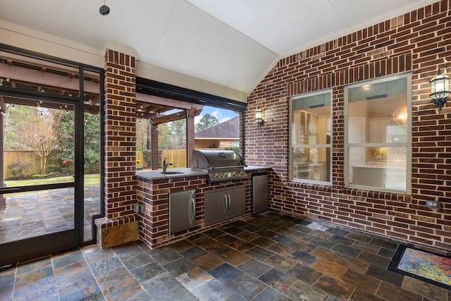 view of patio / terrace featuring area for grilling, a grill, and sink