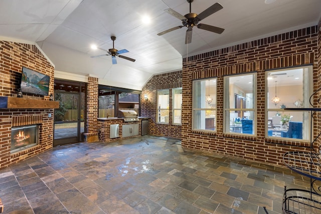 living room with an outdoor brick fireplace, brick wall, lofted ceiling, and ceiling fan