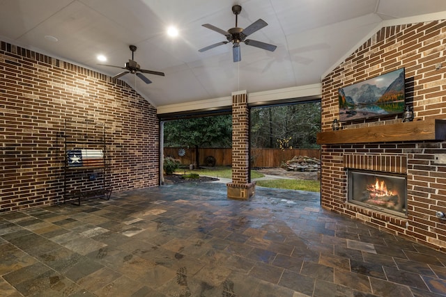 view of patio / terrace featuring an outdoor brick fireplace and ceiling fan