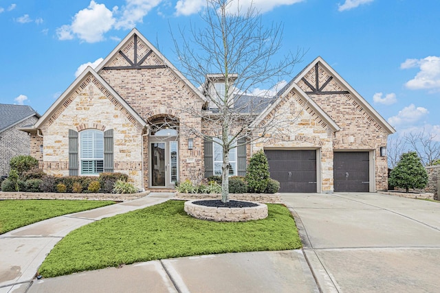 view of front of house featuring a garage and a front lawn