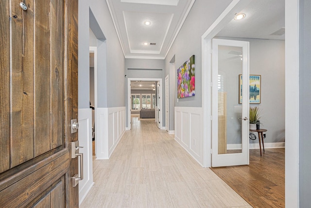 corridor featuring ornamental molding and light wood-type flooring