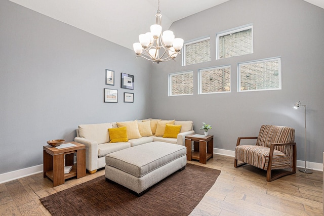 living room featuring lofted ceiling, hardwood / wood-style floors, and a notable chandelier