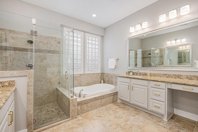 bathroom with independent shower and bath and vanity