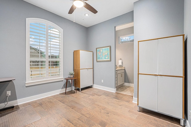 interior space with ceiling fan, plenty of natural light, and light hardwood / wood-style floors