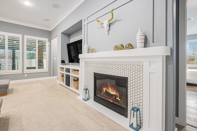 living room featuring ornamental molding and a tiled fireplace