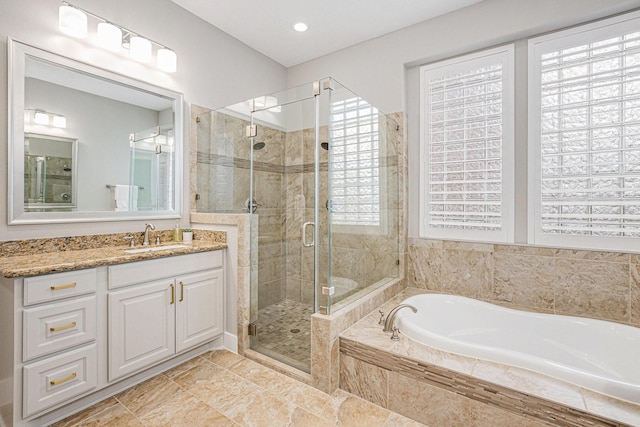 bathroom featuring plus walk in shower and vanity