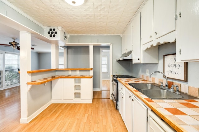 kitchen featuring sink, white cabinetry, tile countertops, light wood-type flooring, and stainless steel electric stove