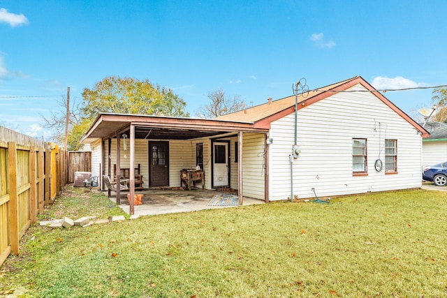 rear view of property with a patio area and a lawn