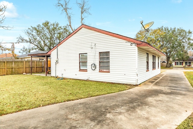 view of side of home with a lawn