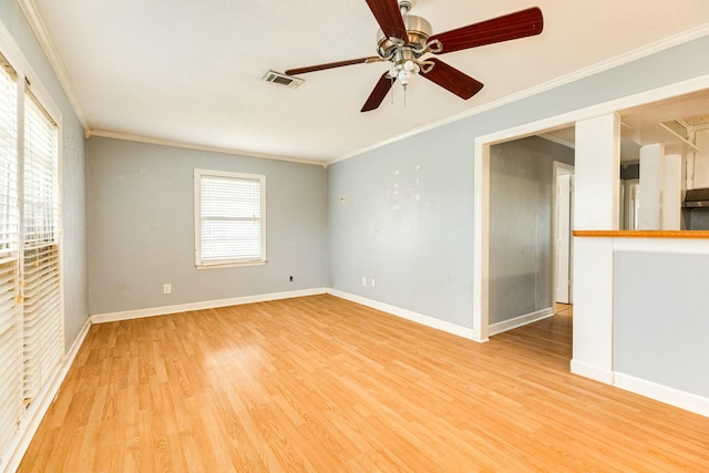 empty room with crown molding, ceiling fan, and light wood-type flooring