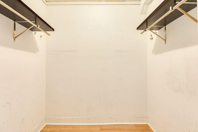 walk in closet with wood-type flooring