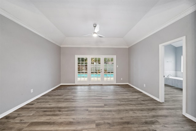 spare room featuring dark wood-type flooring, ceiling fan, and vaulted ceiling