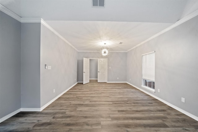 unfurnished room with a notable chandelier, crown molding, and hardwood / wood-style flooring