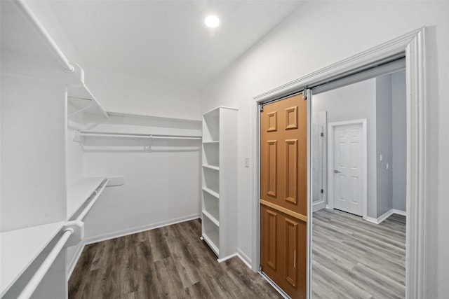 spacious closet featuring hardwood / wood-style flooring