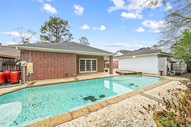 view of pool featuring french doors and a patio area