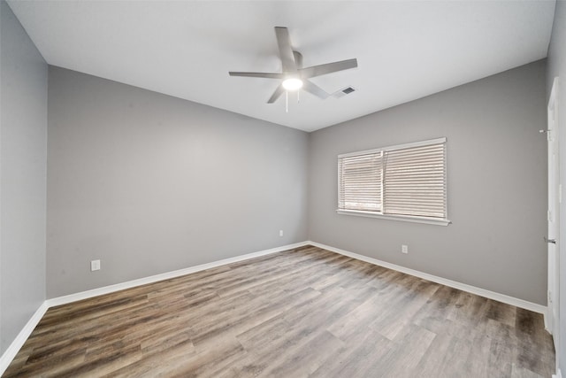 spare room with ceiling fan and light hardwood / wood-style flooring