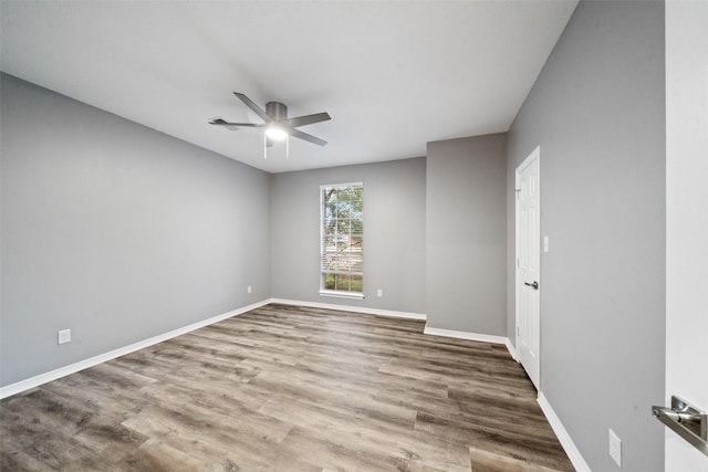 empty room with hardwood / wood-style floors and ceiling fan