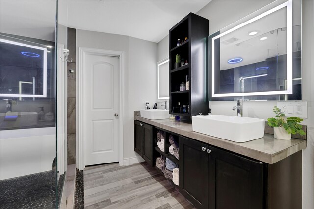 bathroom featuring a shower with door, wood-type flooring, and vanity