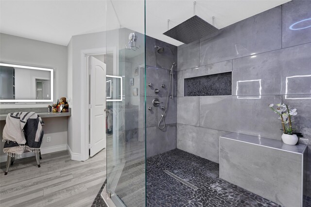 bathroom featuring a shower with shower door and hardwood / wood-style floors