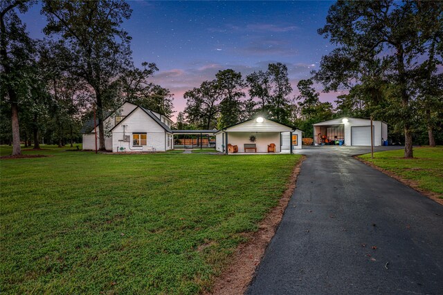 ranch-style house with a carport, a yard, an outdoor structure, and a garage