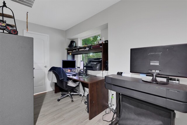 office with light wood-type flooring