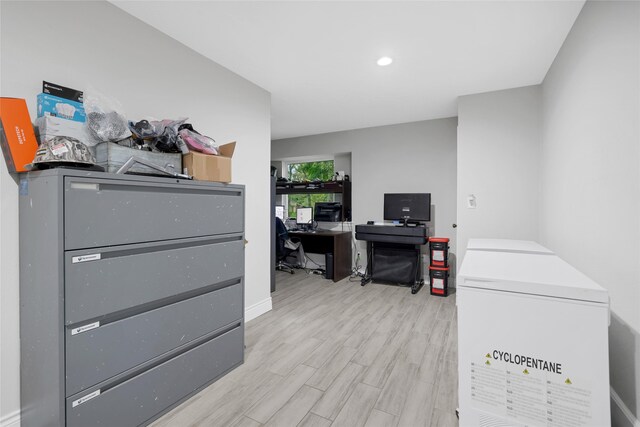 office with light hardwood / wood-style flooring