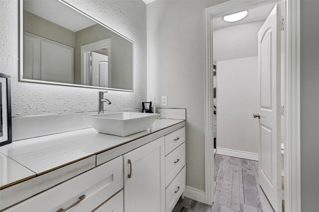 bathroom featuring hardwood / wood-style flooring and vanity