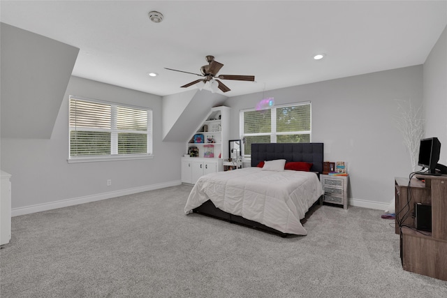 carpeted bedroom with multiple windows and ceiling fan