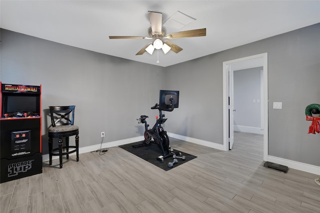 exercise room featuring ceiling fan and light hardwood / wood-style floors