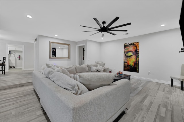 living room with ceiling fan and light wood-type flooring