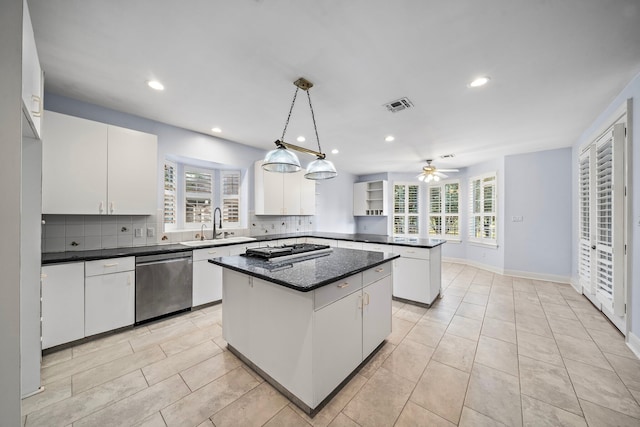 kitchen with white cabinetry, stainless steel dishwasher, decorative light fixtures, and a center island