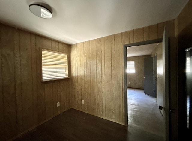 unfurnished room with wood walls