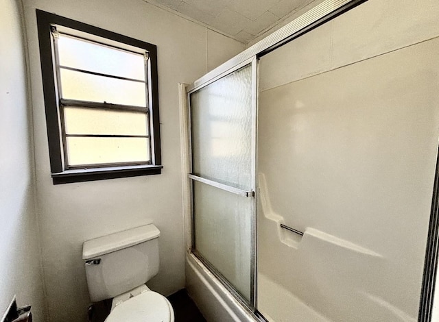 bathroom featuring shower / bath combination with glass door and toilet