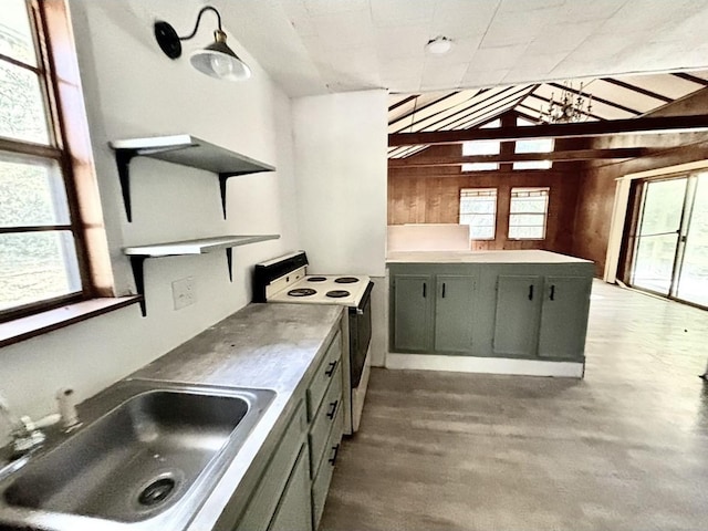 kitchen with vaulted ceiling, dark hardwood / wood-style floors, wooden walls, white electric stove, and sink