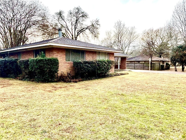 view of side of property with a yard