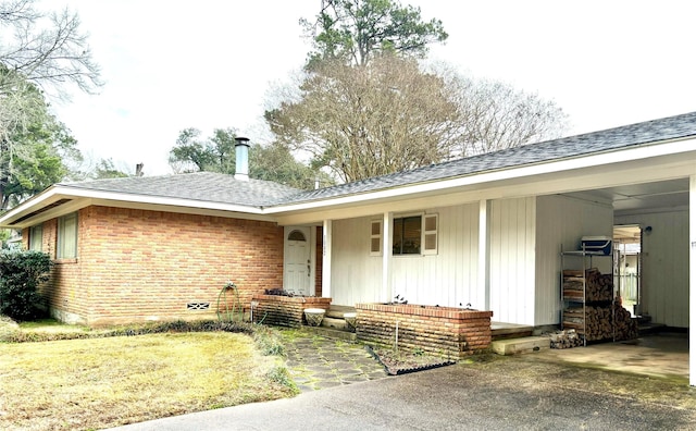 view of front of home with a carport and a front lawn