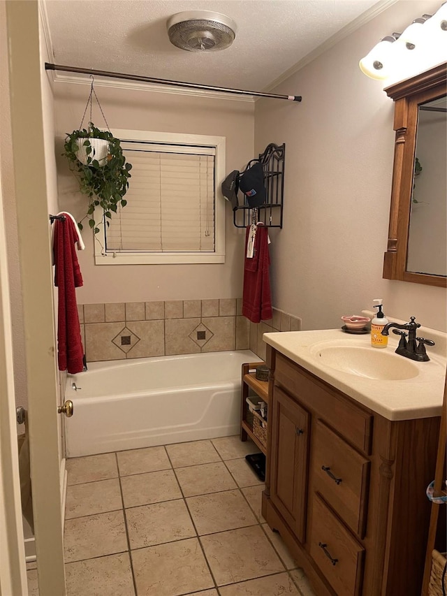 bathroom featuring tile patterned floors, crown molding, a textured ceiling, vanity, and a tub