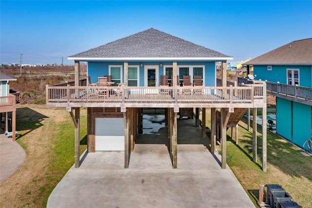 back of property with a carport, a porch, and a yard