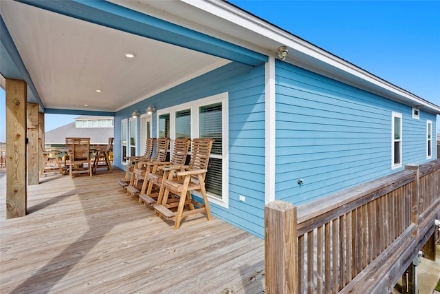 wooden terrace with outdoor dining area