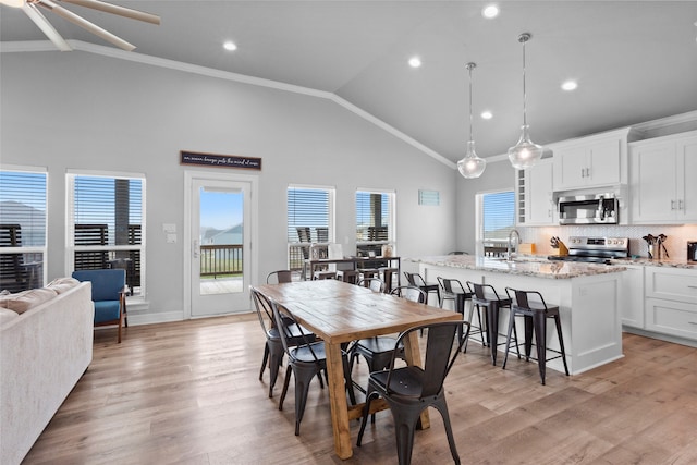 dining room featuring recessed lighting, light wood-type flooring, and ornamental molding