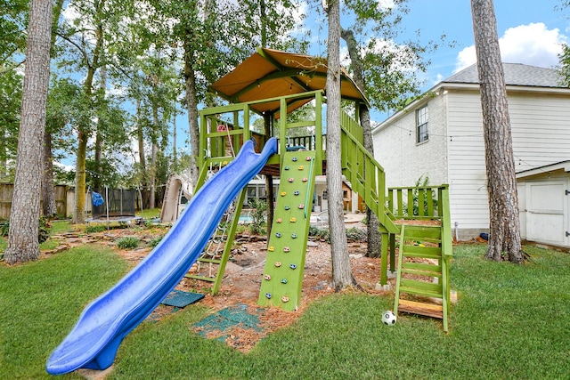 view of jungle gym with a trampoline and a lawn