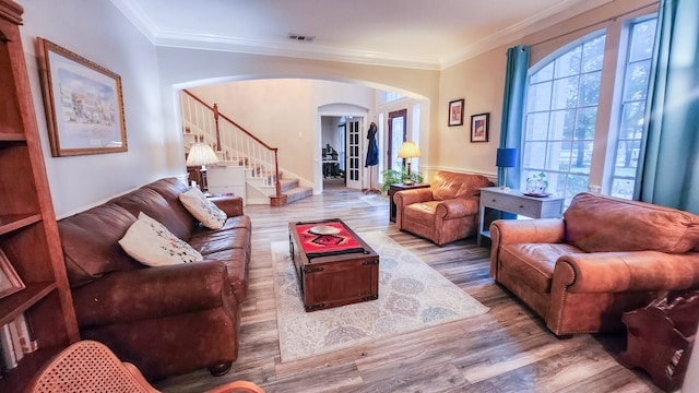 living room with crown molding and hardwood / wood-style flooring