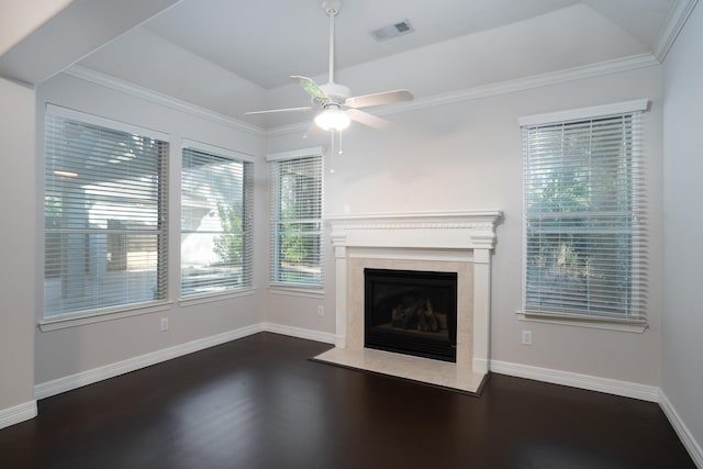 unfurnished living room featuring ceiling fan, ornamental molding, dark wood-type flooring, and a fireplace