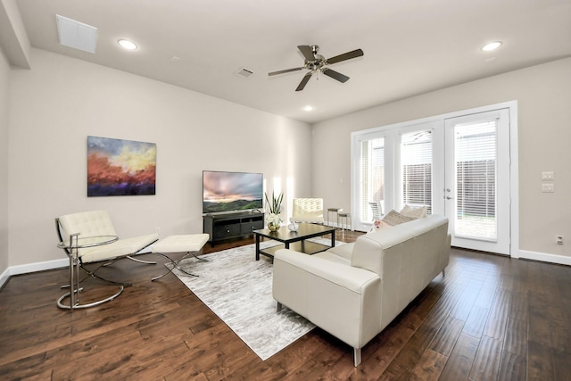 living room featuring dark wood-type flooring and ceiling fan