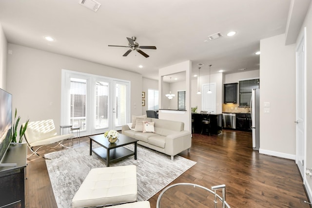 living room featuring dark hardwood / wood-style floors and ceiling fan