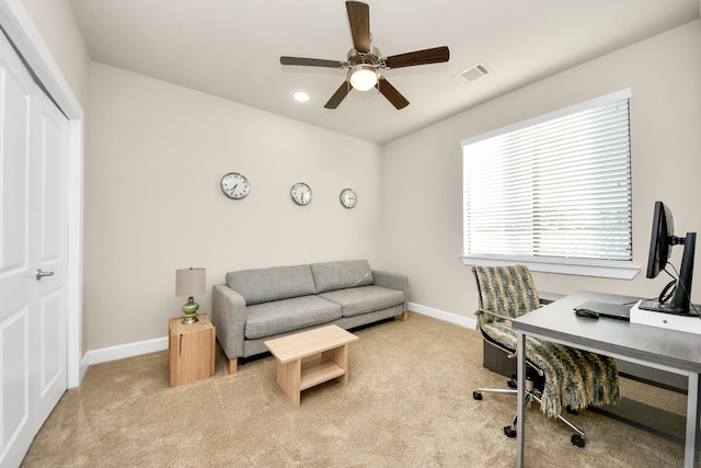 carpeted home office featuring ceiling fan