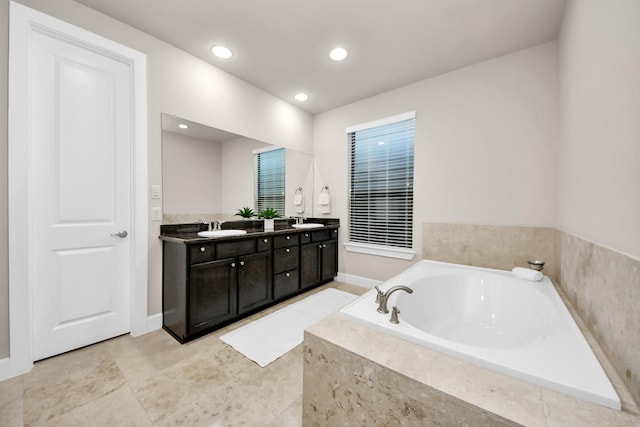 bathroom with vanity and a relaxing tiled tub