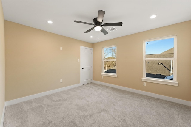 spare room featuring light carpet, baseboards, visible vents, and recessed lighting