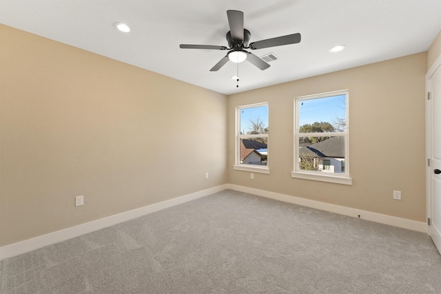 unfurnished room with carpet, visible vents, baseboards, and recessed lighting