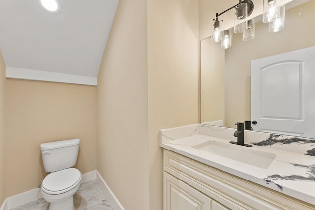 half bath featuring toilet, marble finish floor, baseboards, and vanity